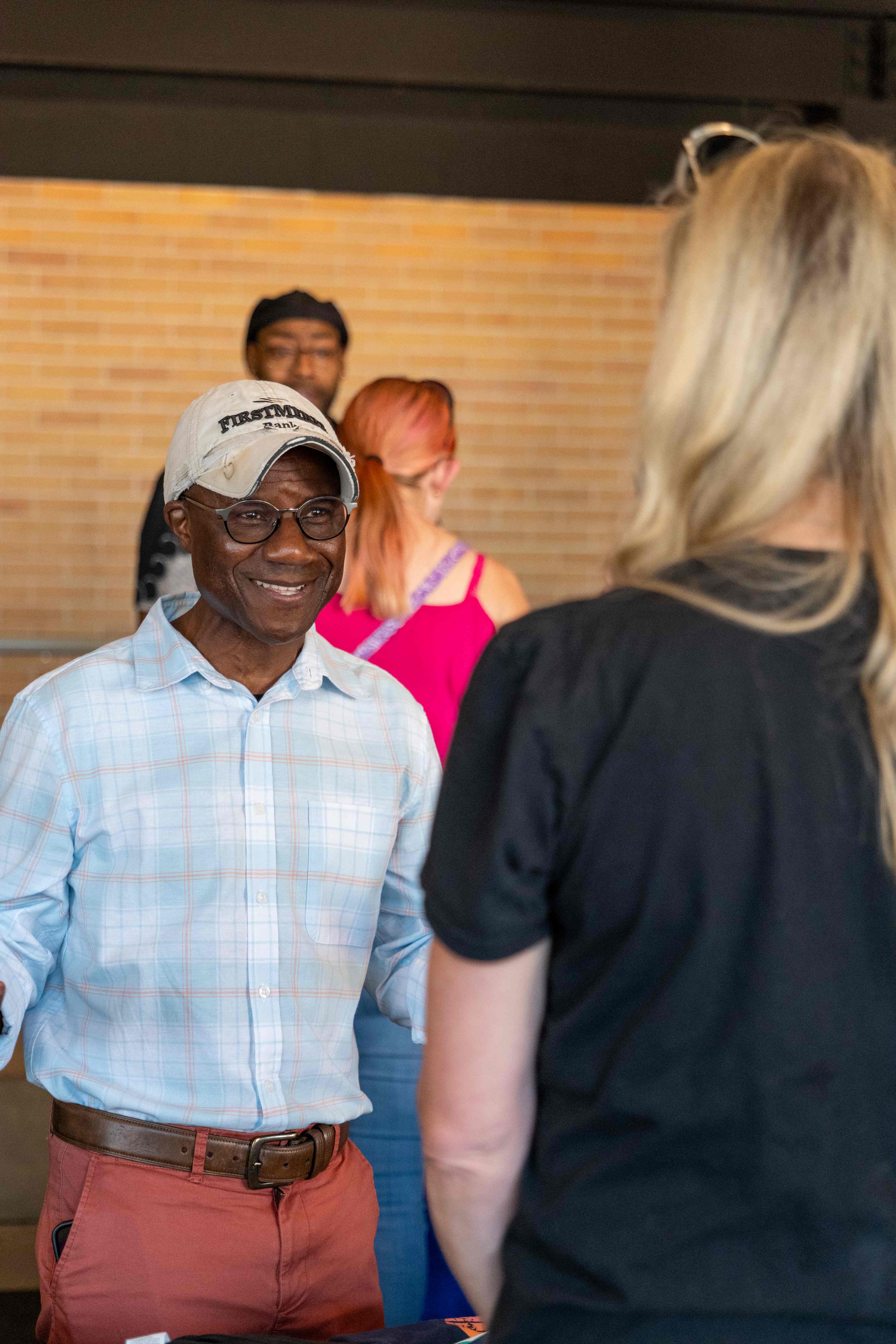 Community ACCESS Line volunteer assisting attendee
